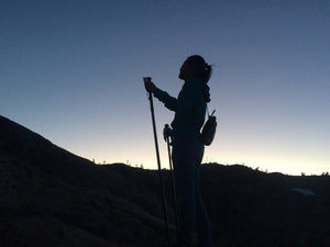 nighttime-earthtrek-trekking-hiking-mountain-trail-stick-with-woman-hiker